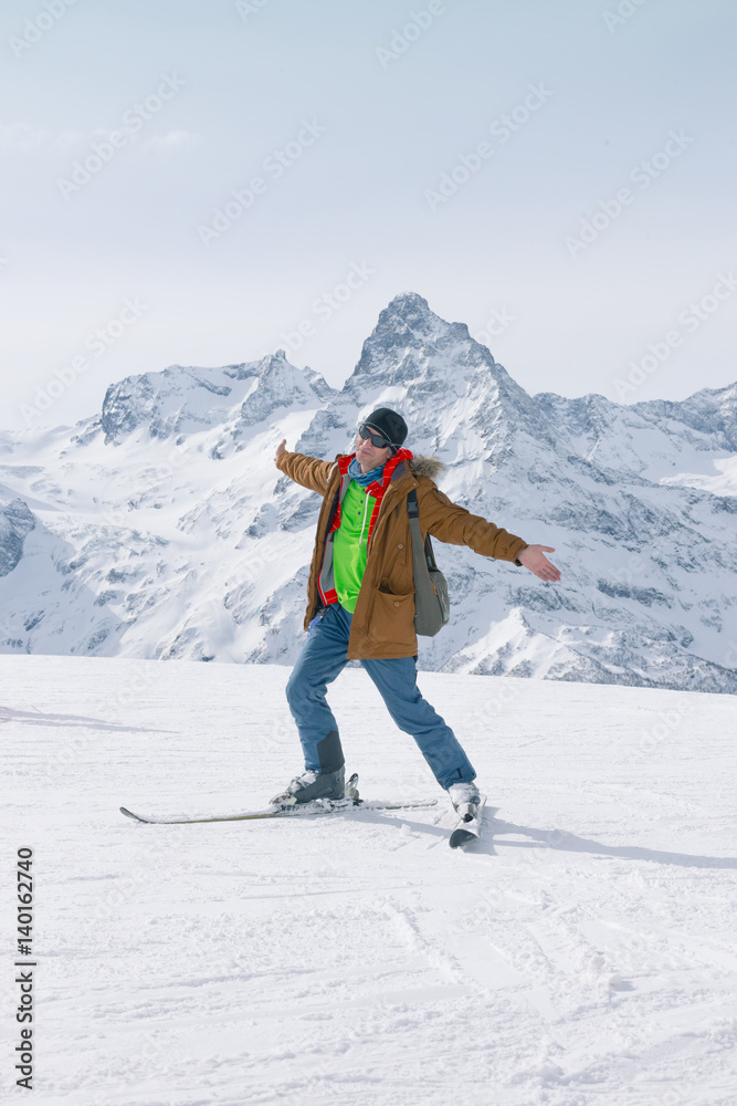 Alpine skiing in the high mountains. Active positive skier.