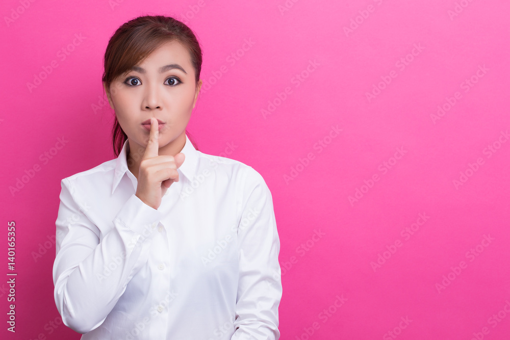 Asian woman make quiet gesture Asian woman make quiet gesture