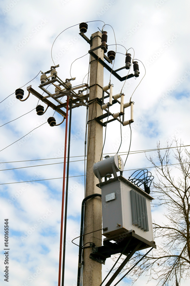 Distribution electrical transformer mounted on a pole. Electric utility. Distribution electrical power system. Distribution electrical transformer mounted on a pole. Electric utility. Distribution electrical power system.