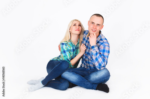 Romantic young couple sitting on floor.