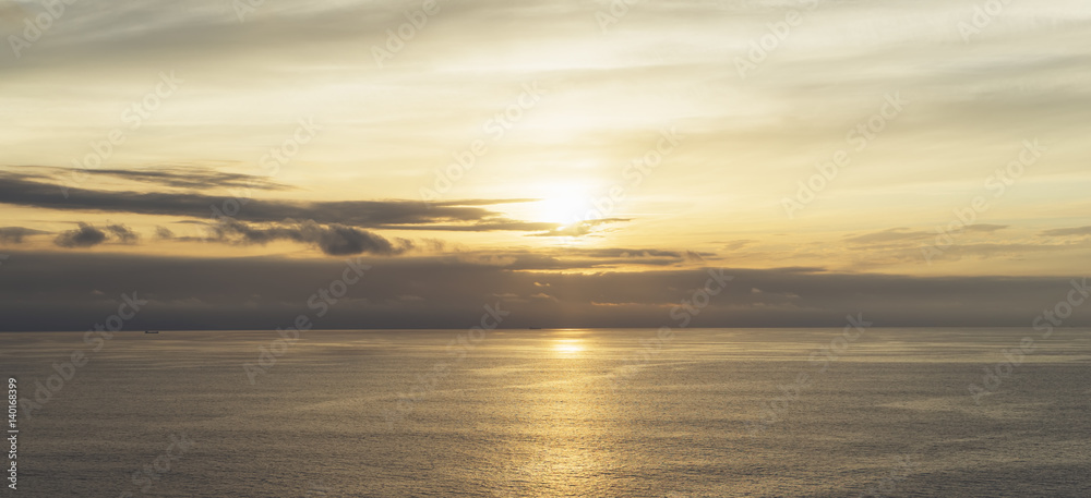 Clouds sky and sunlight gold sunset on horizon ocean. Background seascape dramatic atmosphere rays sunrise. Relax view waves water sea, mock up nature evening concept perspective sunrise