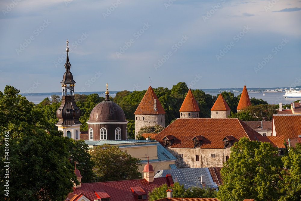 Red roofed towers of old Tallinn and Russian Orthodox church. Summer sunny day.