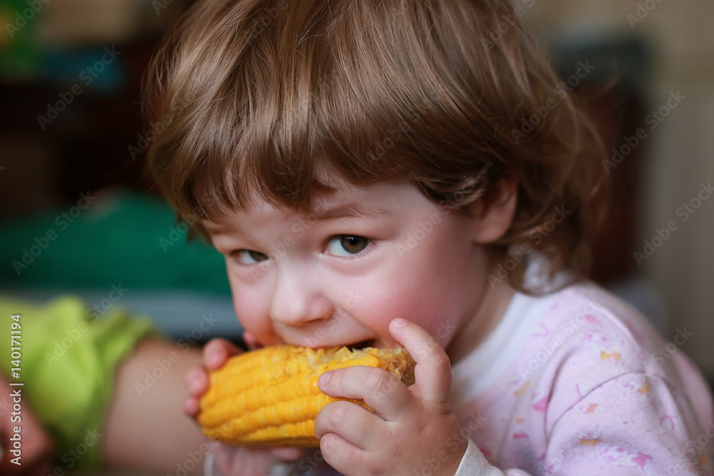 little boy eats greedily biting corn little boy eats greedily biting corn