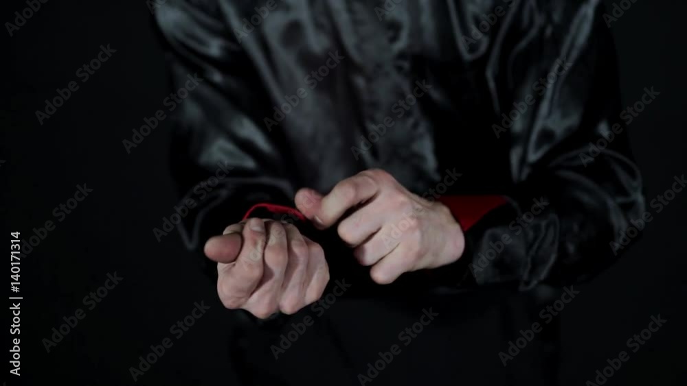 The coin disappears from the magician's hands and smoke coming out of his hand The coin disappears from the magician's hands and smoke coming out of his hand