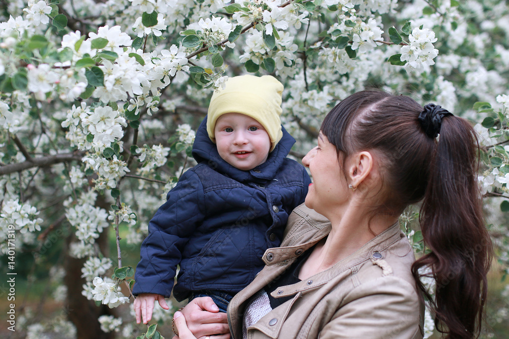 girl with daughter in a spring apple garden girl with daughter in a spring apple garden