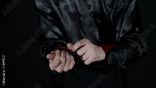 The coin disappears from the magician's hands and smoke coming out of his hand
