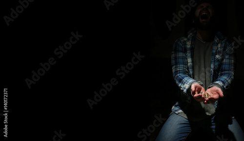 black background with bullet in hands man