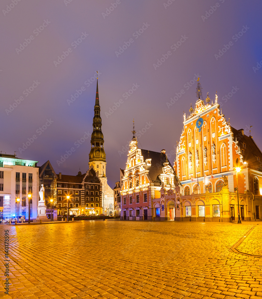 RIGA, LATVIA - 20 JUN 2016: City Hall Square with House of the Blackheads and Saint Peter church in Riga Old Town at night. RIGA, LATVIA - 20 JUN 2016: City Hall Square with House of the Blackheads and Saint Peter church in Riga Old Town at night.