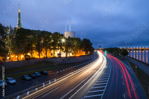 Night scene with traffic, old town and river bank in Riga, Latvia