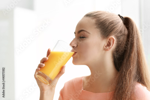 Young beautiful woman drinking juice