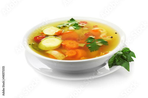 Bowl with vegetable soup on white background