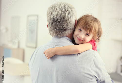 Girl embracing grand father...