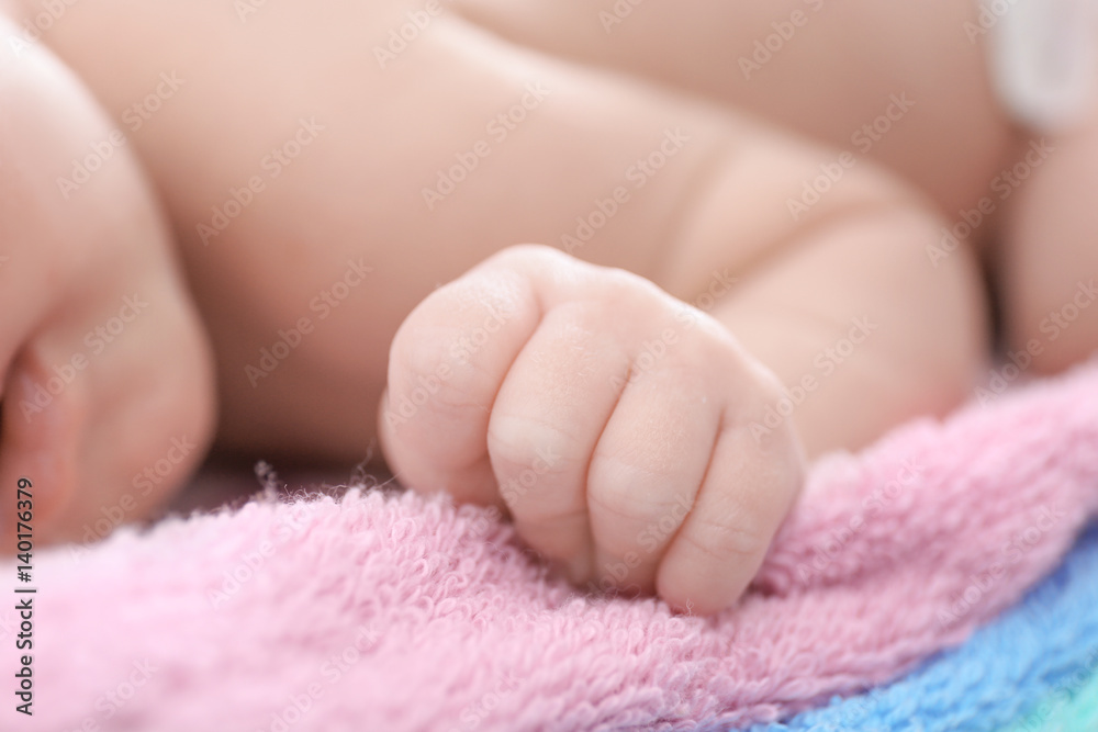 Hand of cute little baby lying on towels at home, closeup Hand of cute little baby lying on towels at home, closeup