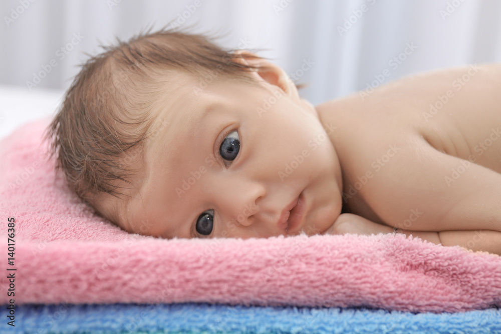 Cute little baby lying on towels at home, closeup Cute little baby lying on towels at home, closeup