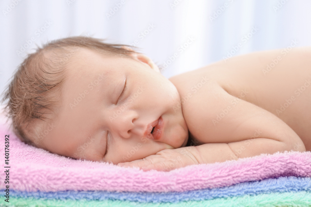 Cute little baby sleeping on towels at home, closeup Cute little baby sleeping on towels at home, closeup