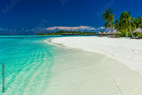 Palm trees over stunning lagoon and white sandy beach © Martin Valigursky