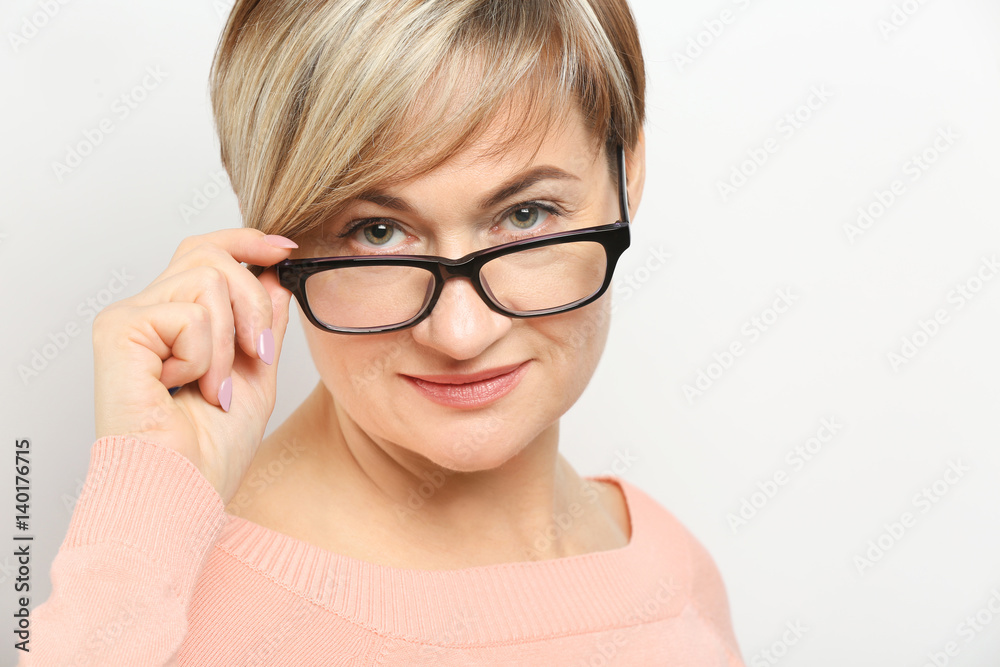 Mature woman wearing glasses on white background