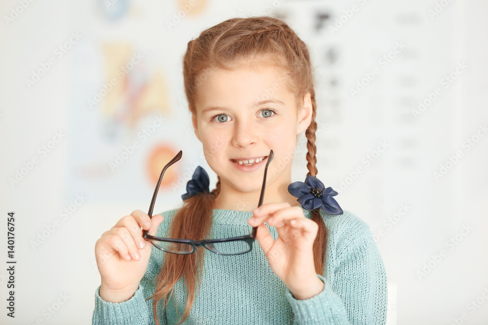 Cute little girl with glasses in ophthalmologist's office Stock Photo