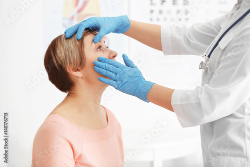 Ophthalmologist examining e...