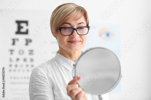 Mature woman with mirror tr...