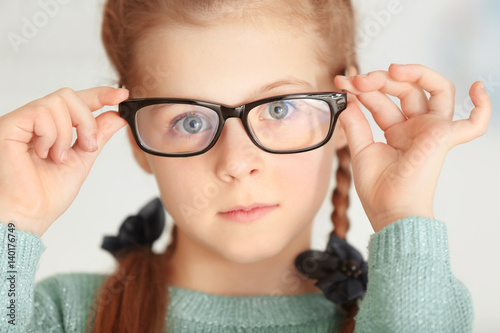 Cute little girl with glass...