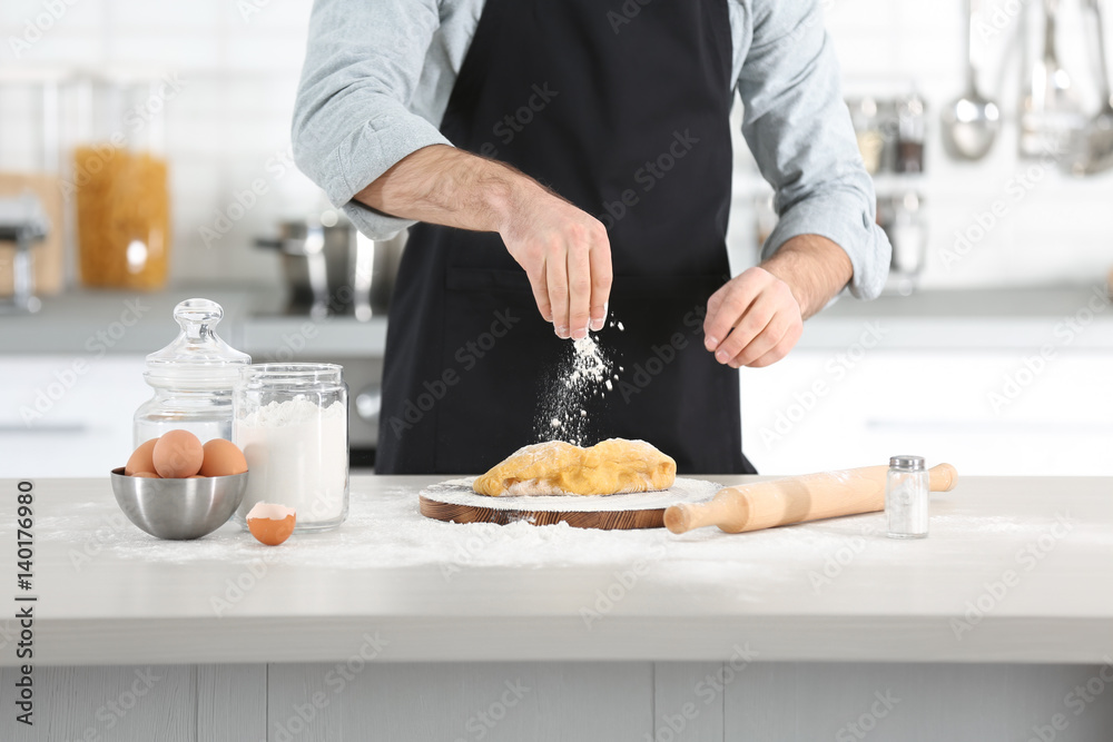 Man preparing pasta on kitchen table Man preparing pasta on kitchen table