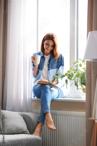 Young beautiful woman readi...