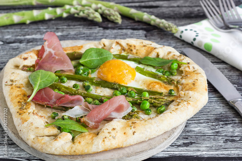 Homemade  galette with egg, asparagus, peas and ham.