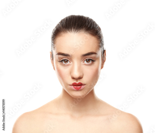 Portrait of beautiful young woman with heart painted on lips  against white background