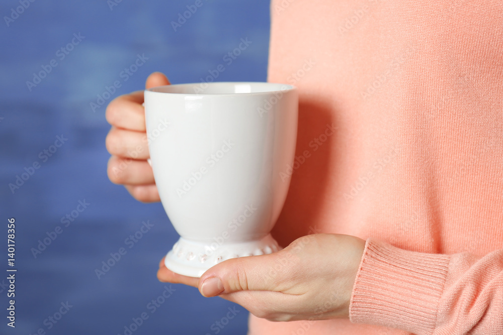 Blank white cup in hands, closeup Blank white cup in hands, closeup