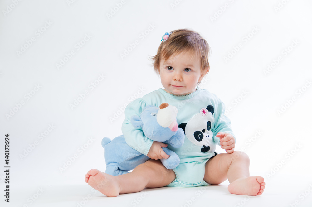 Portrait of a smiling child with a toy bear, isolated on a white background Portrait of a smiling child with a toy bear, isolated on a white background