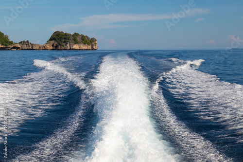 The waves from a high-speed boat and island background,selective focus.