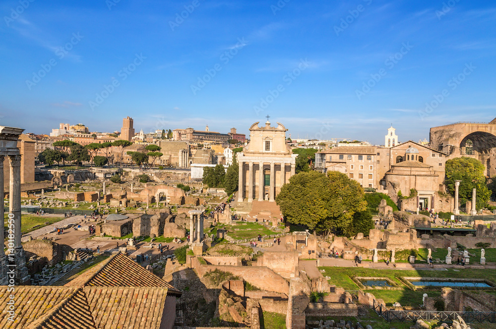 Rome, Italy. Ancient ruins of Roman Forum: Temple of Deified Julius, Temple of Vesta, House of Vestals, Temple of Antoninus and Faustina, Temple of Romulus, Basilica of Maxentius
