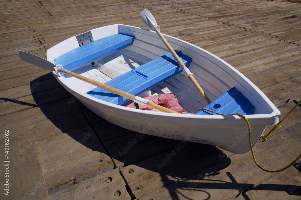 Fototapeta premium Blue and White Dinghy on a Dock