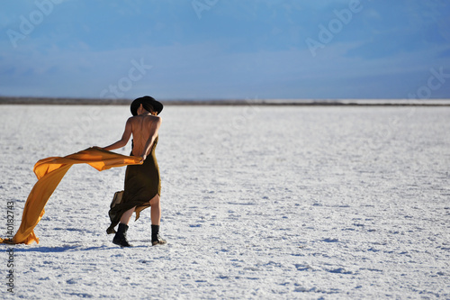 Girl with Hat Walking on Badwater Basin in Death Valley, California