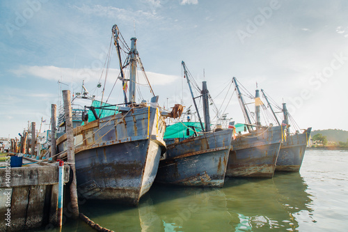 Fishing boats in a harbour and a blue sky. photo