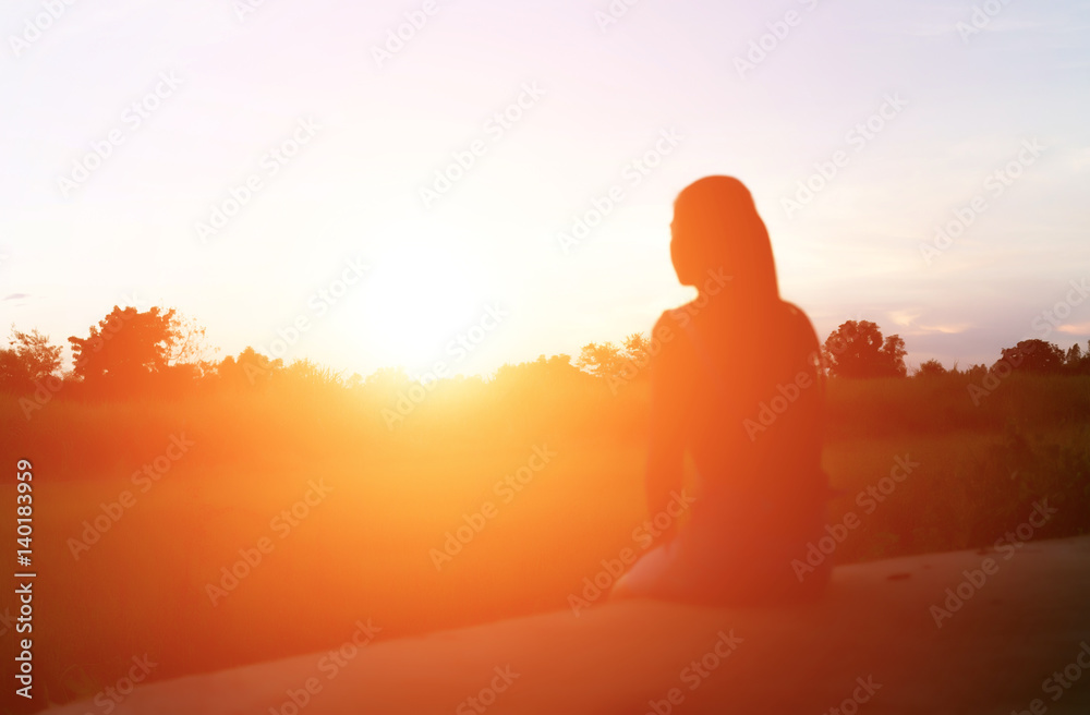 silhouette woman sitting on mountain in morning and vintage filter