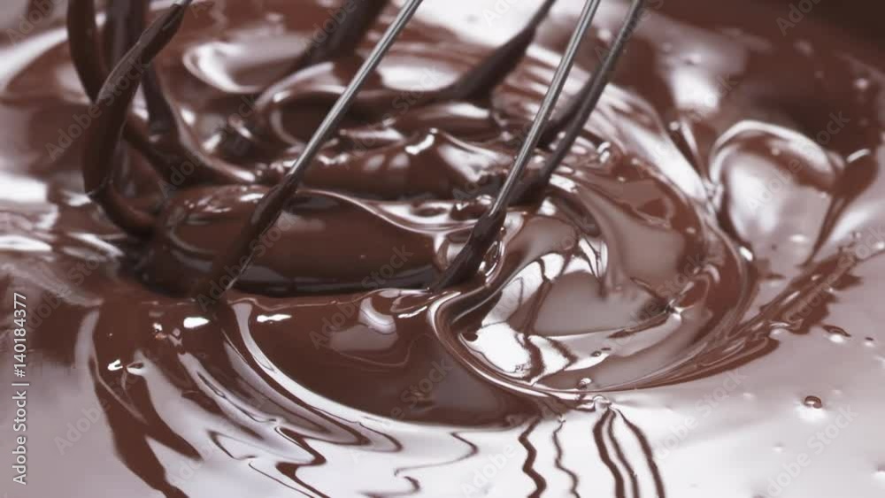 Slow motion of checking melted premium dark chocolate with a whisk, 180fps prores footage Slow motion of checking melted premium dark chocolate with a whisk, 180fps prores footage
