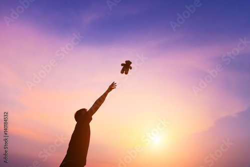 Silhouette of man praying over beautiful sky sunset background. The concept is ripe destination