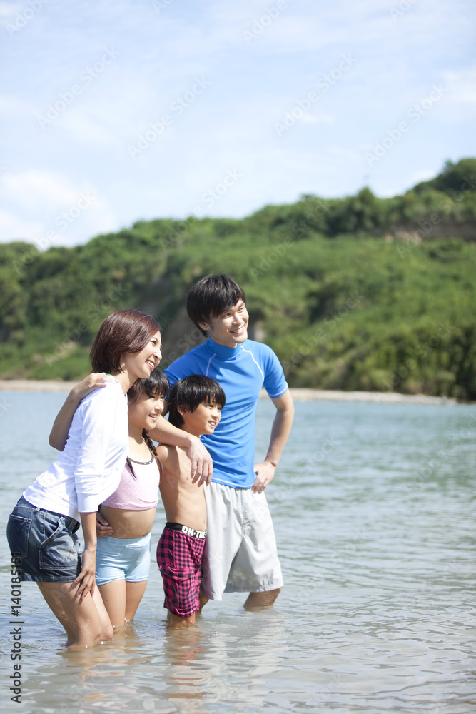 A happy family standing together in sea A happy family standing together in sea
