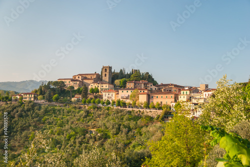 Old Italian village on the top of the hill forming typical tuscan landscape