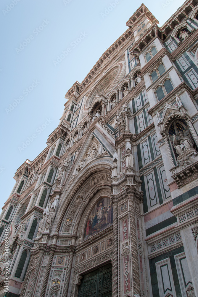 Fototapeta premium Florence cathedral entrance with detailed ornaments and white and green marble facade