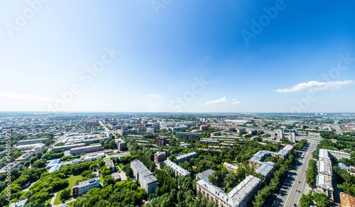 Aerial city view with crossroads, roads, houses, buildings, parks and parking lots. Copter drone helicopter shot. Panoramic wide angle image. © mr.markin