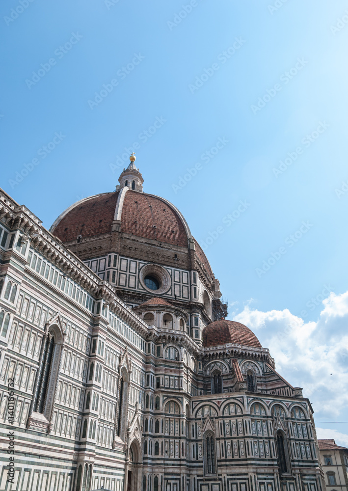 Florence cathedral with iconic duomo and white and green marble facade