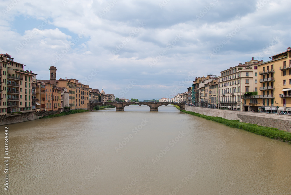 Bridge on the river Arno in Florence, Italy with colorful rustic buildings on the edge