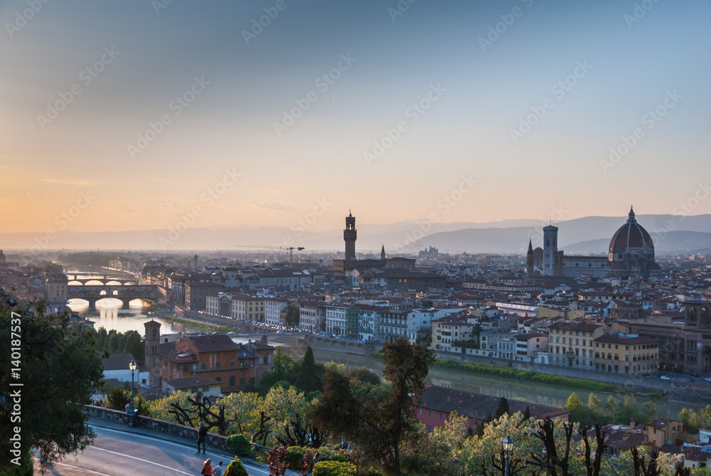 Panoramic view of Florence, Italy at dusk with iconic buildings and bridges