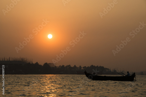 Sunset at the port with many boats in the center of Chittagong in Bangladesh
