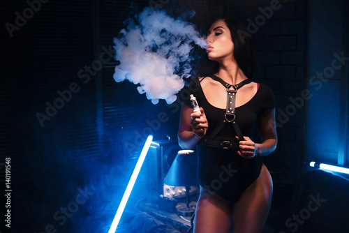 vapor concept,sexy woman in lingerie vaping Electronic hookah photo