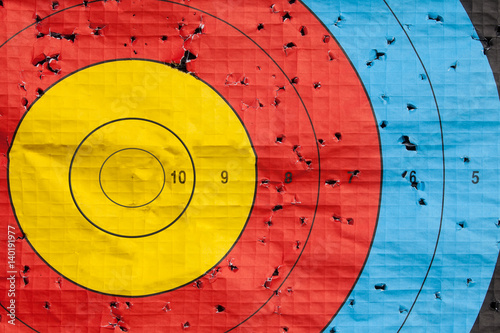 Missed the target concept with large target peppered with holes except the gold bullseye photo