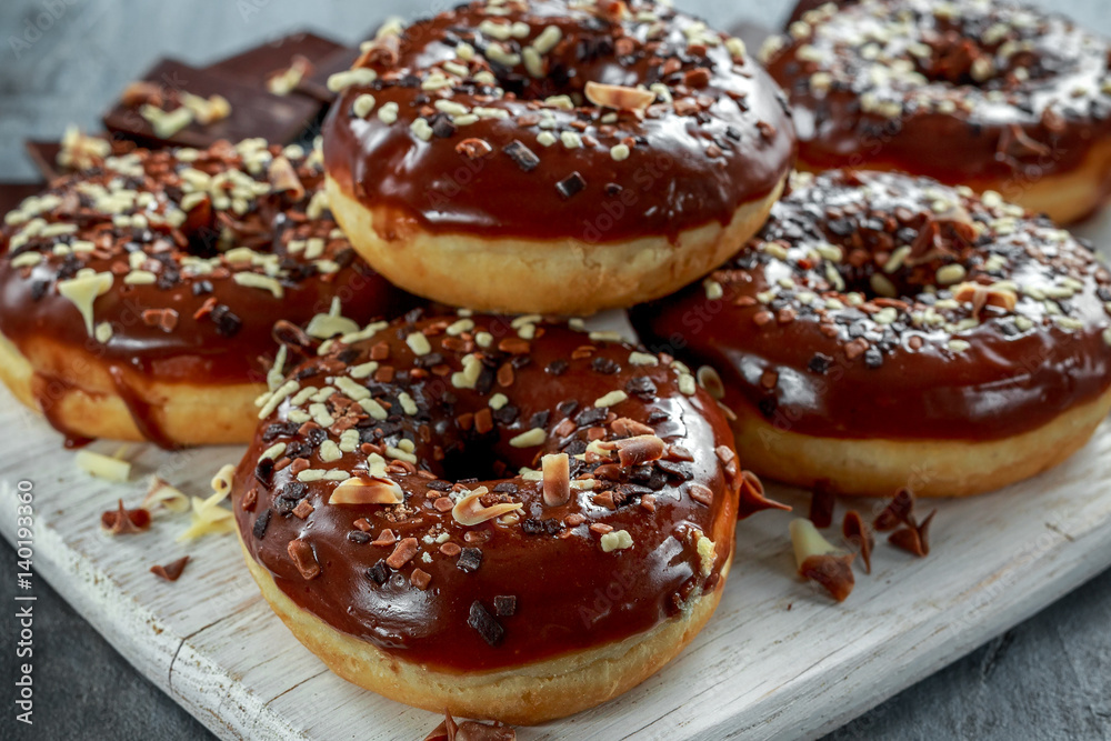 donut rings with white and dark chocolate chippings and icing served on board donut rings with white and dark chocolate chippings and icing served on board
